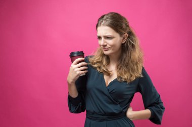 Arka planda kahve fincanı olan genç bir kadın.