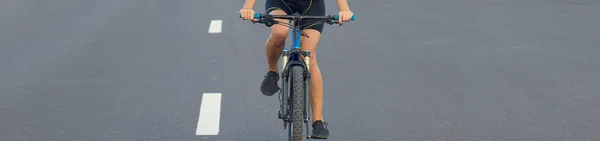 young woman riding bicycle on the road