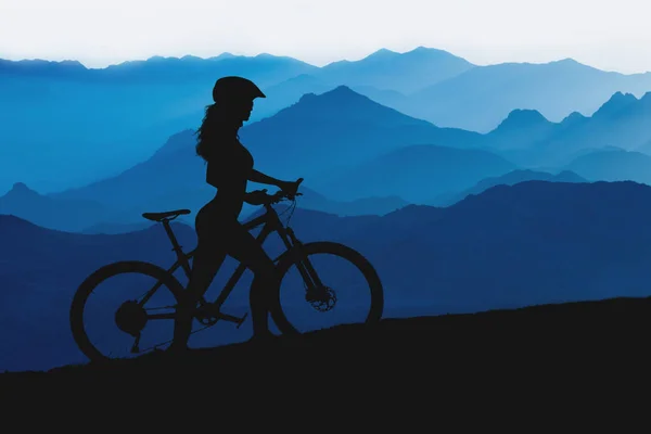 silhouette of a mountain bike with a bicycle on the background of mountains