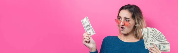 young beautiful woman with money on color background