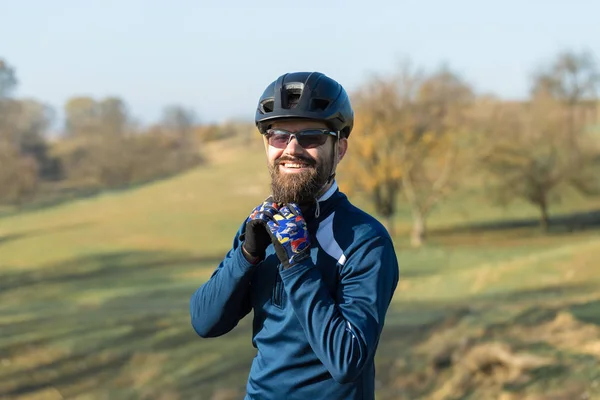 Cyclist in pants and fleece jacket on a modern carbon hardtail bike with an air suspension fork. The guy on the top of the hill rides a bike.