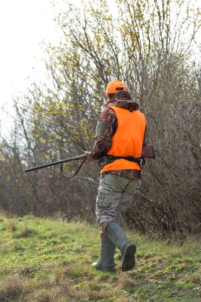 오렌지 조끼를 남자가 안개낀 날씨에 나무가 우거진 지역에서 사냥을 있었습니다 — 스톡 사진