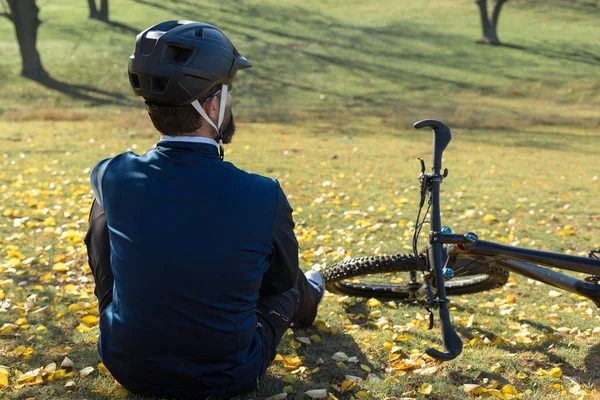 Cyclist in pants and fleece jacket on a modern carbon hardtail bike with an air suspension fork. The guy on the top of the hill rides a bike.