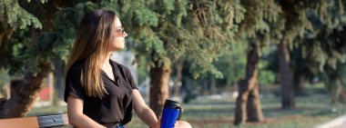 Genç bir kız parkta bir bankta oturur ve notlar alır. Serbest stil giyinmiş. İş kadını müşterilerle telefonda konuşuyor. Dinlenme ve kahve içme zamanı.