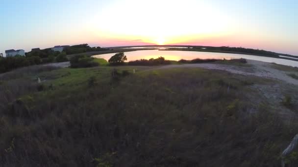 Aerial lift to beautiful sunset over sound — Stock Video