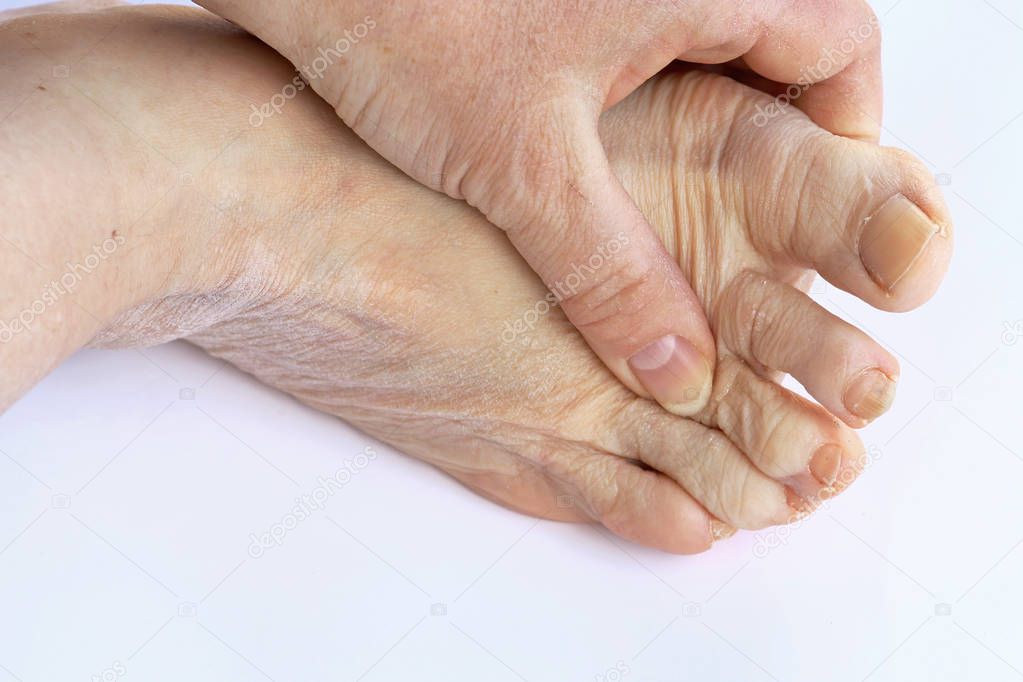 An elderly woman has pain in the feet and toes