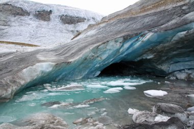 Glacier Cave - A cave with blue ice in the glacier in Austria clipart