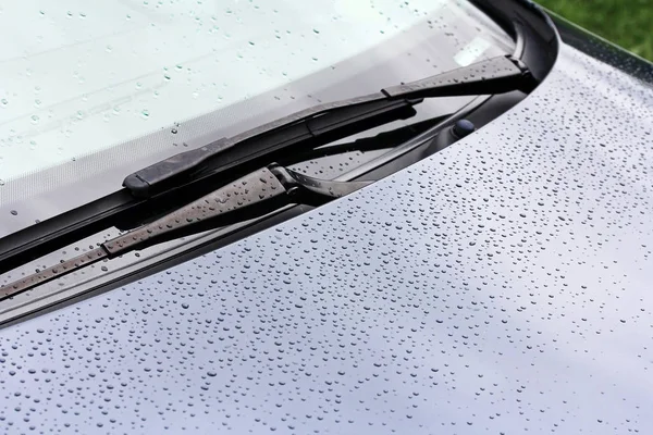 Rainy weather and road traffic. Raindrops on a car