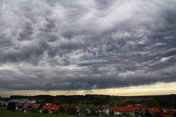 Dark eerie storm clouds over a city — Stock Photo, Image