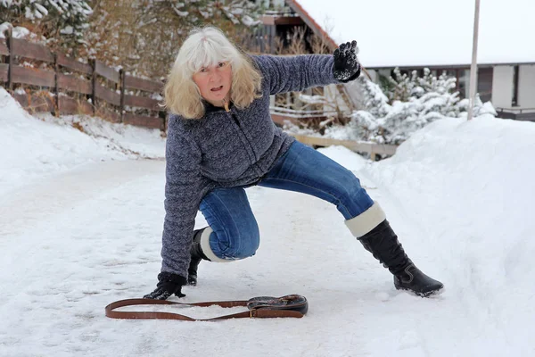 Kaza kış tehlikede. Bir kadın dışarı pürüzsüz sokakta fişleri