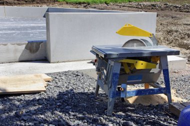 Table saw with saw blade at a construction site clipart