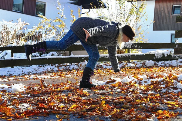 秋と冬に滑りのリスク。女性がぬれた滑らかな葉で滑った — ストック写真