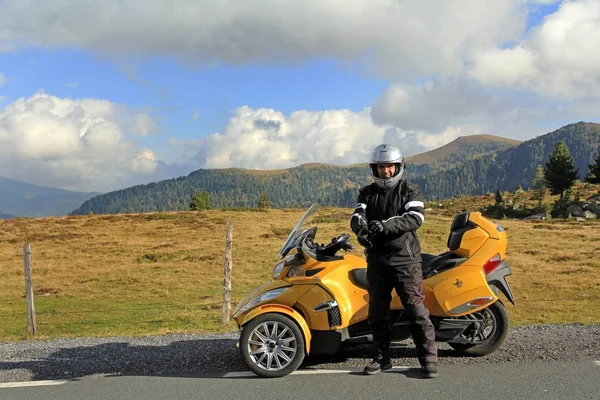 Motorsport in the mountains. Good motorcycle clothing offers safety in motorsport