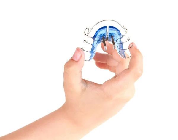 Orthodontic treatment in a child's hand, isolated on a white background — Stock Photo, Image
