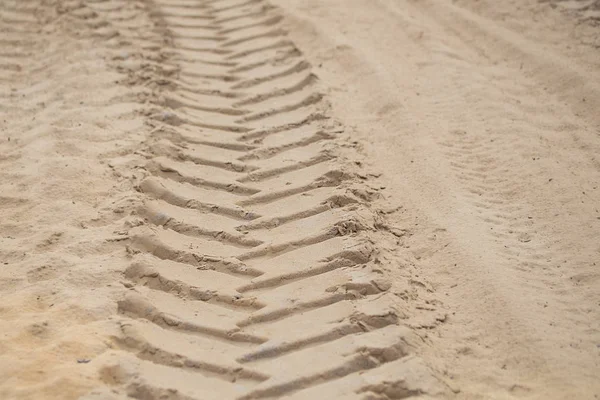 A trace on a sand of big wheel truck or tractor