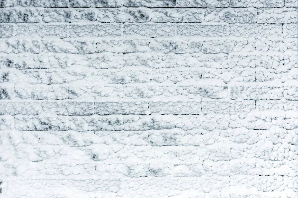 Mur z cegły pokryte światła niebieski snow. Iced zima chropowatości powierzchni. Miejsce do lokowania produktu lub tekst — Zdjęcie stockowe