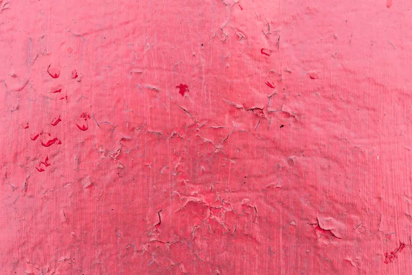 Cracked red paint texture. Close-up of old painted red wall. Abstract grunge background. Vintage scratched surface