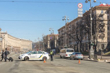Kiev,Ukraine - May 06, 2017:Central street of ukrainian capital Kyiv Khreschatyk closed for traffic by police car and officer. Pedestrian area in centre. Toursist walking by crosswalk clipart