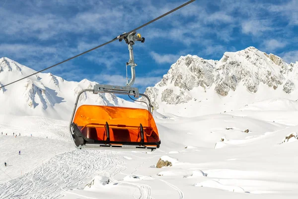 Remontées mécaniques sur les collines station d'hiver de montagne alpine par une journée ensoleillée. Téléski télésiège téléphérique avec les gens aiment le ski et le snowboard.Bannière panoramique large vue sur les pistes de descente — Photo