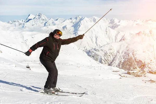 Senior mature happy funny skier having fun and fooling around at winter alpine skiing resort. Old aged sporty person enjoy vacation at mountain Alps snow slope outdoors during cold snowy day — Stock Photo, Image