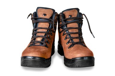 Pair of new modern high brown leather hiking boots isolated on white background. Two trekking rough warm winter footwear shoes. Male outdoor travel and activities equipment