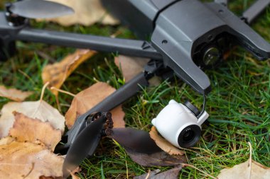 Kaza sonrası kara kuadkopter insansız hava aracı kaza yaptıktan sonra yeşil çimlerin üzerinde yatıyordu. Güçlü rüzgar paraziti nedeniyle uzaktan kumanda arızası. Çatlak kamera titremesi ve plastik bacaklar..