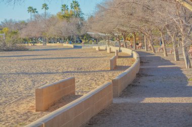 A walkway and beach along the Colorado River at the Rotary Community Park in Lake Havasu City, Arizona USA clipart