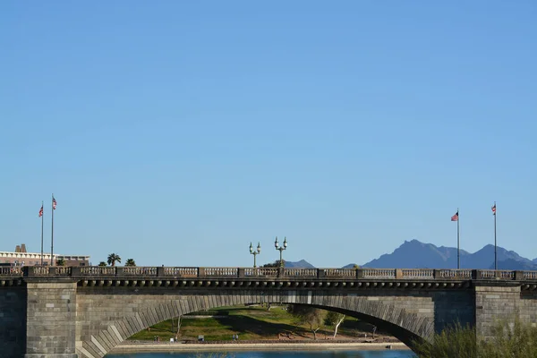 London Bridge is in Lake Havasu City, Arizona. It links an island in the Colorado River with the main part of Lake Havasu City. It formerly spanned the River Thames in London, England