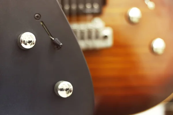Guitarra eléctrica de primer plano con un enfoque suave de color negro, controles de tono, volumen . —  Fotos de Stock