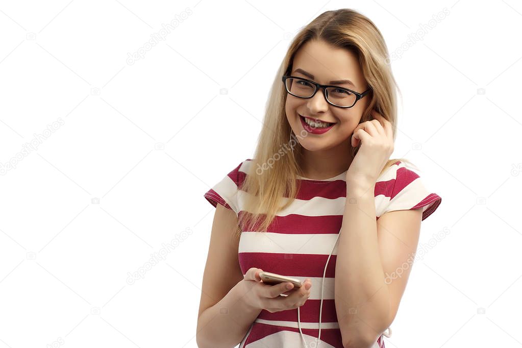 Beautiful happy teenage girl listens to music through the headphones isolated on white.