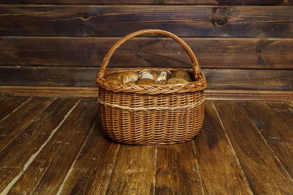 Mushroom basket on the wooden floor — Stock Photo, Image