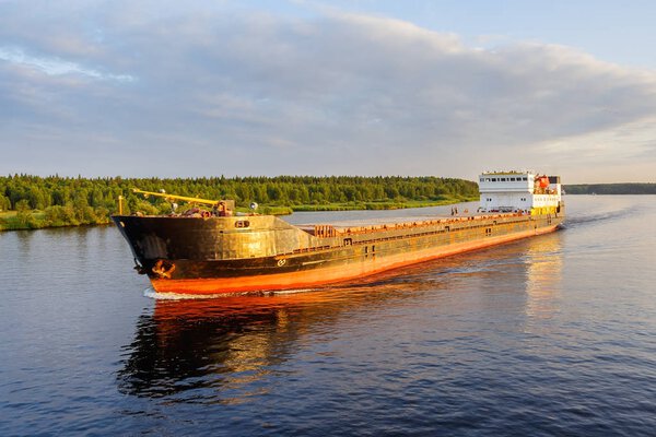 Cargo ship in the rays of sunset