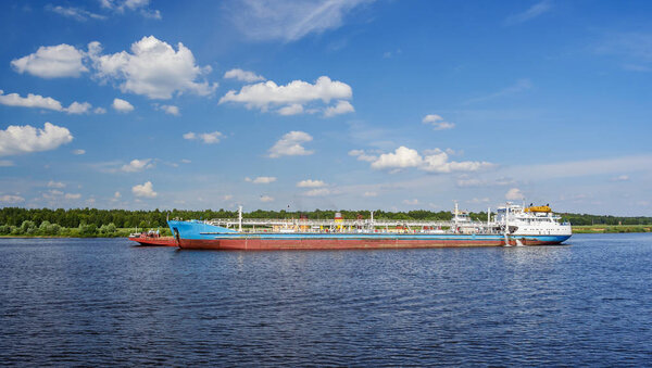 Cargo ship near the shore of river