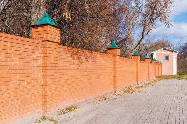 Kırmızı tuğla çit ile pembe bir evde