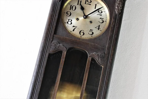 An Image of a vintage pendulum clock