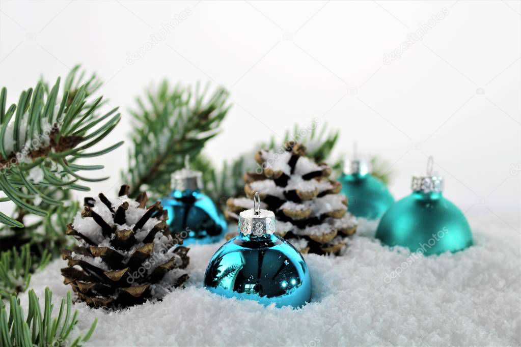 An Image of Christmas decoration with balls, snow and tree
