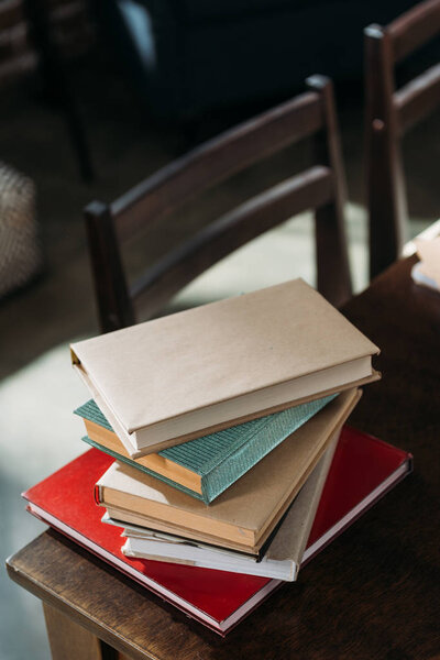 close up of heap of books on wooden tabletop with copy space