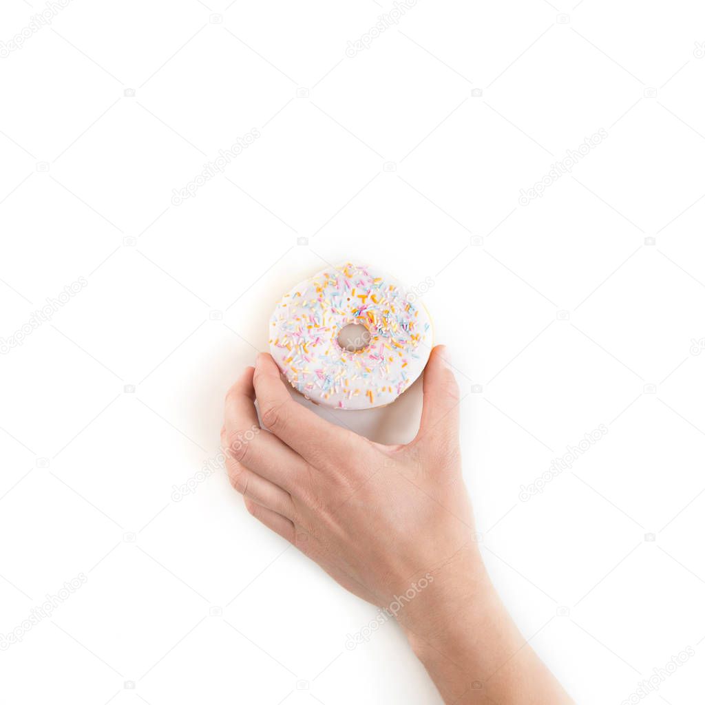 Cropped shot of person holding fresh tasty donut isolated on white