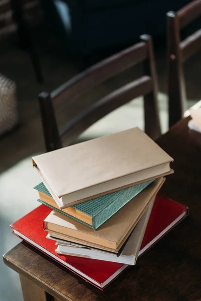 Close up of heap of books on wooden tabletop with copy space — Stock Photo