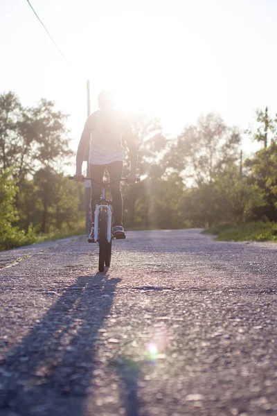 Stock image The boy ride on bike at sunrise background