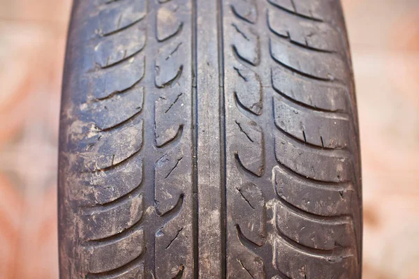 Old car tire with erased tread — Stock Photo, Image