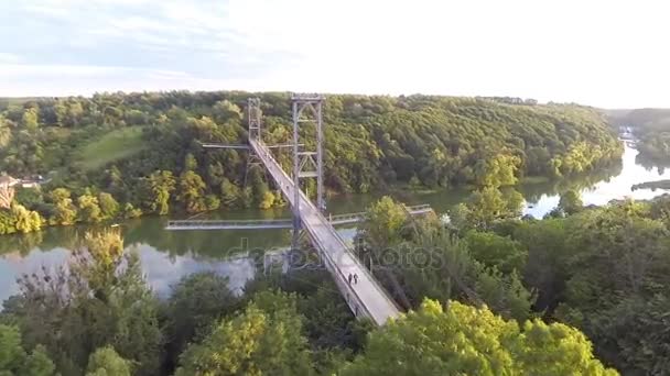 Aerial view of a pedestrian bridge across the river — Stock Video