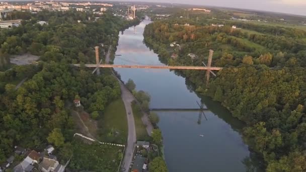Aerial view of a pedestrian bridge across the river — Stock Video