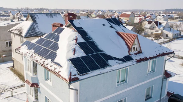 Solar panels on the roof of the house after a heavy snowfall in the winter