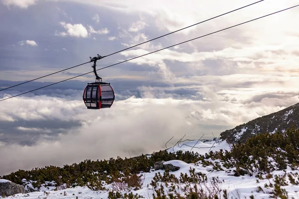 Cableway cabin above the clouds at sunset — Stock Photo, Image
