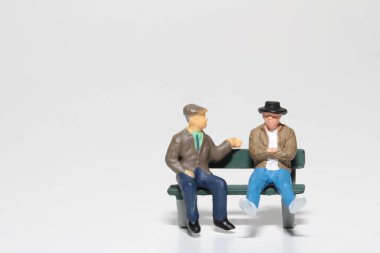 miniature people talking on a bench clipart