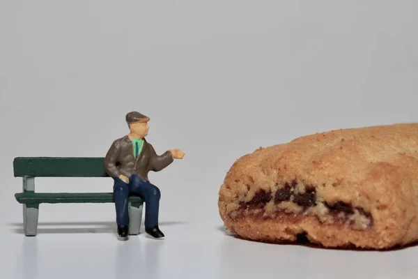 old man with a giant biscuit - diabetes concept