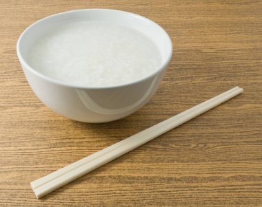 Soft Boiled Rice or Rice Porridge with Chopsticks clipart