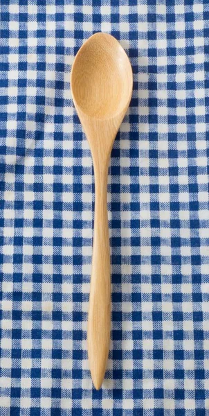 Brown Wooden Spoon on Blue Checked Napkin Pattern
