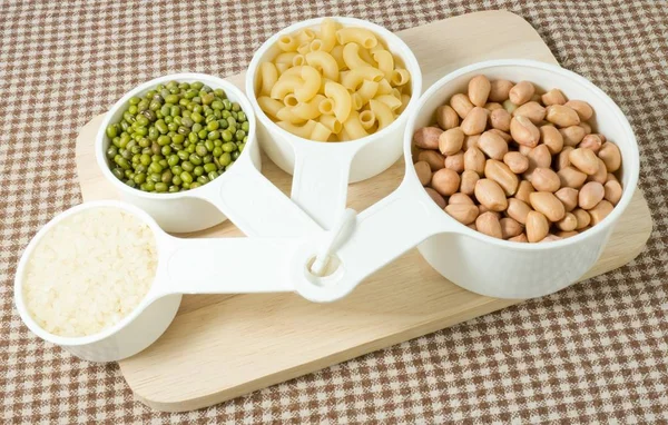 Pasta, Rice, Peanuts and Mung Beans in Measuring Cups